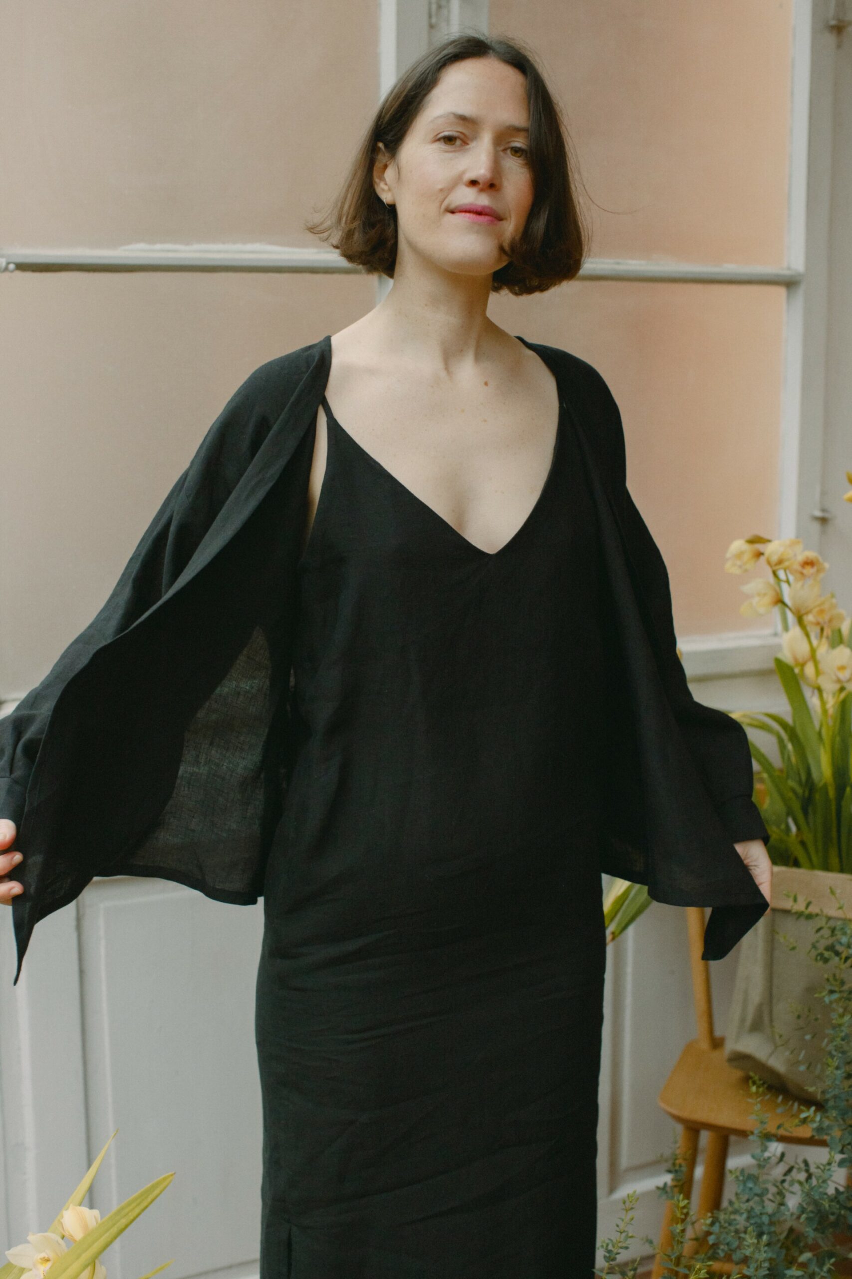 Leinenkleid in Schwarz aus 100 % niederländischem Leinen, Trägerkleid mit Vorder- und Rückenausschnitt, Seitenschlitzen und seitlichen Eingriffstaschen.